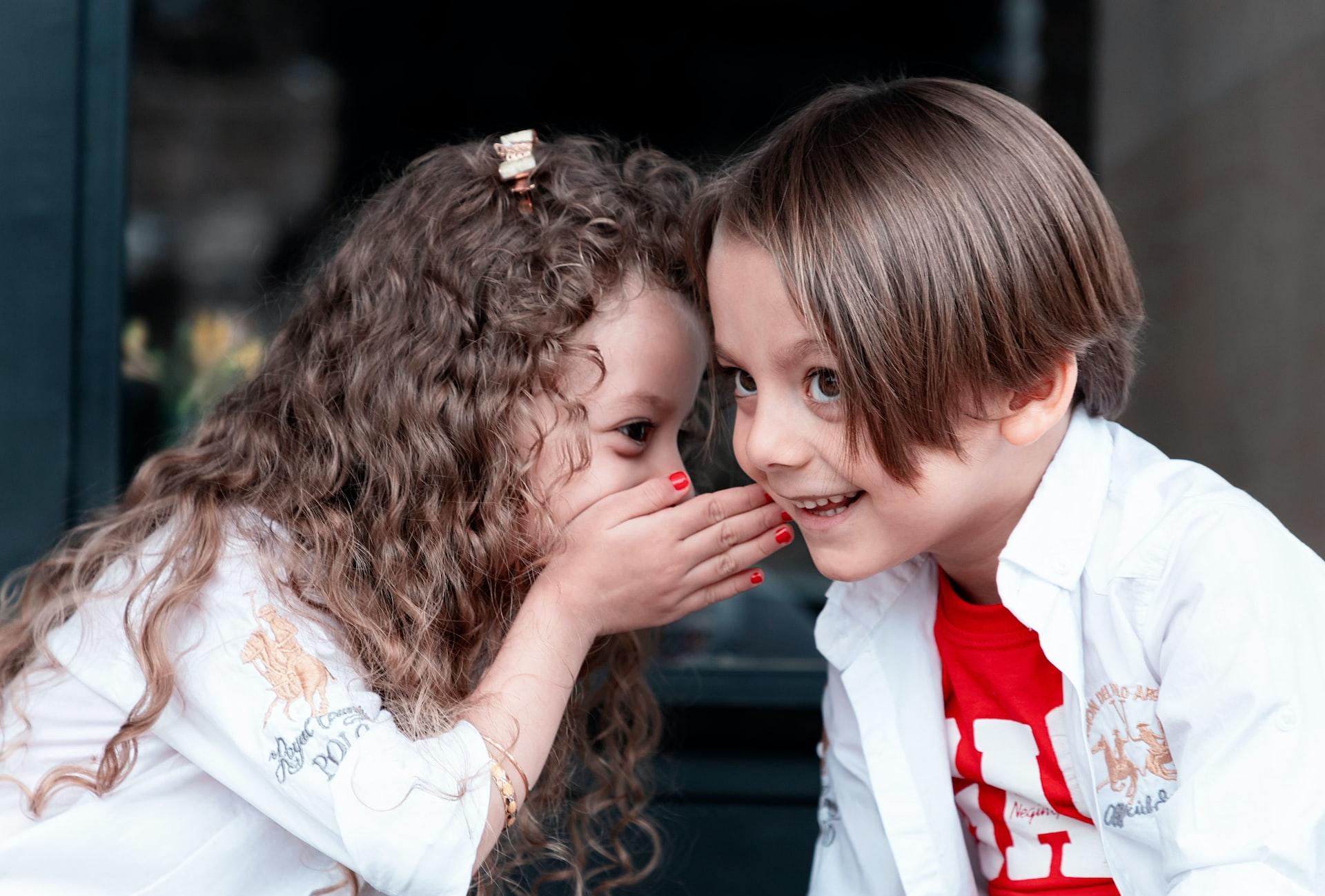 woman in white long sleeve shirt kissing girl in white long sleeve shirt